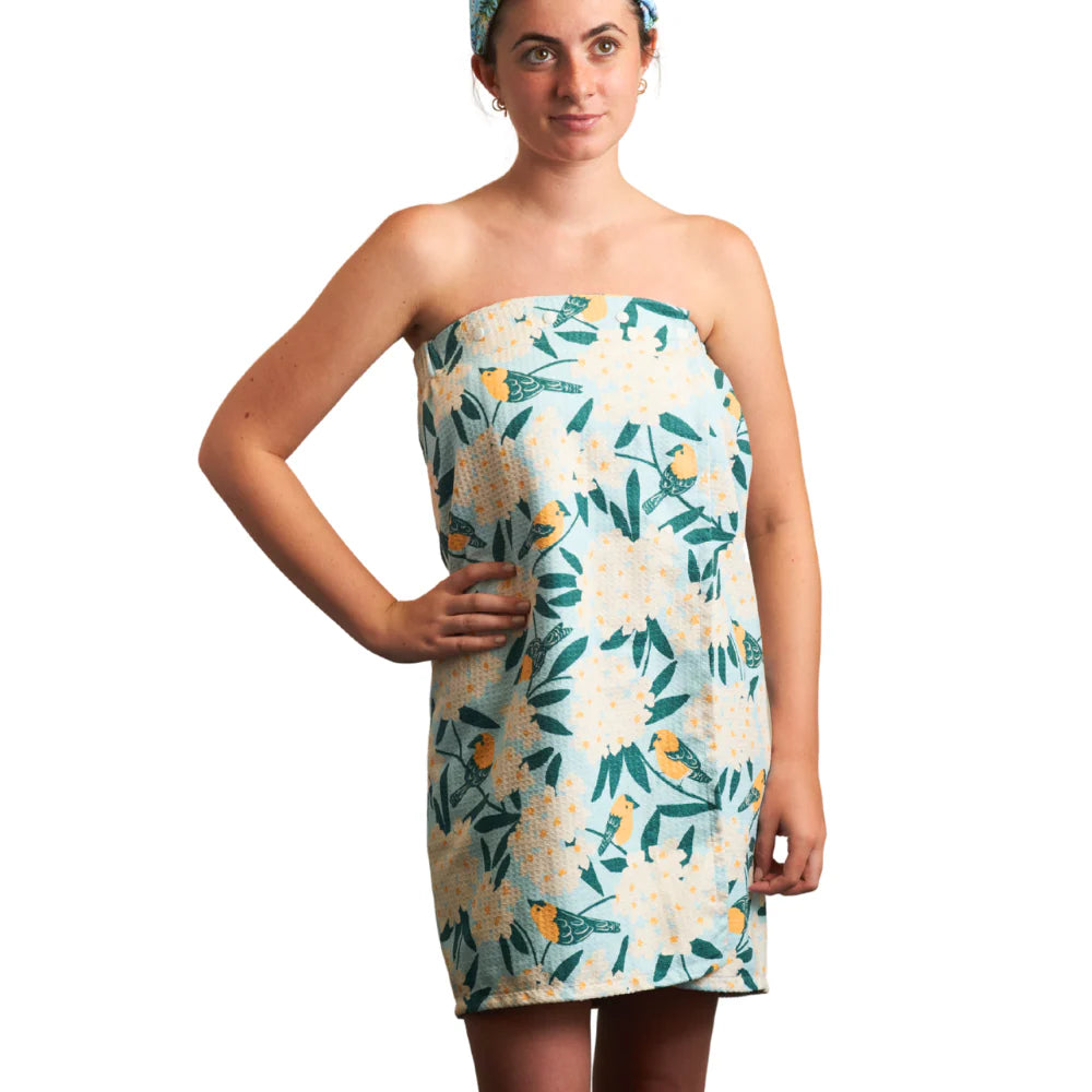 Woman wearing a floral strapless dress on a white background