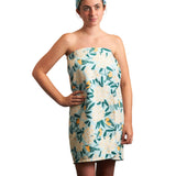 Woman wearing a floral strapless dress on a white background