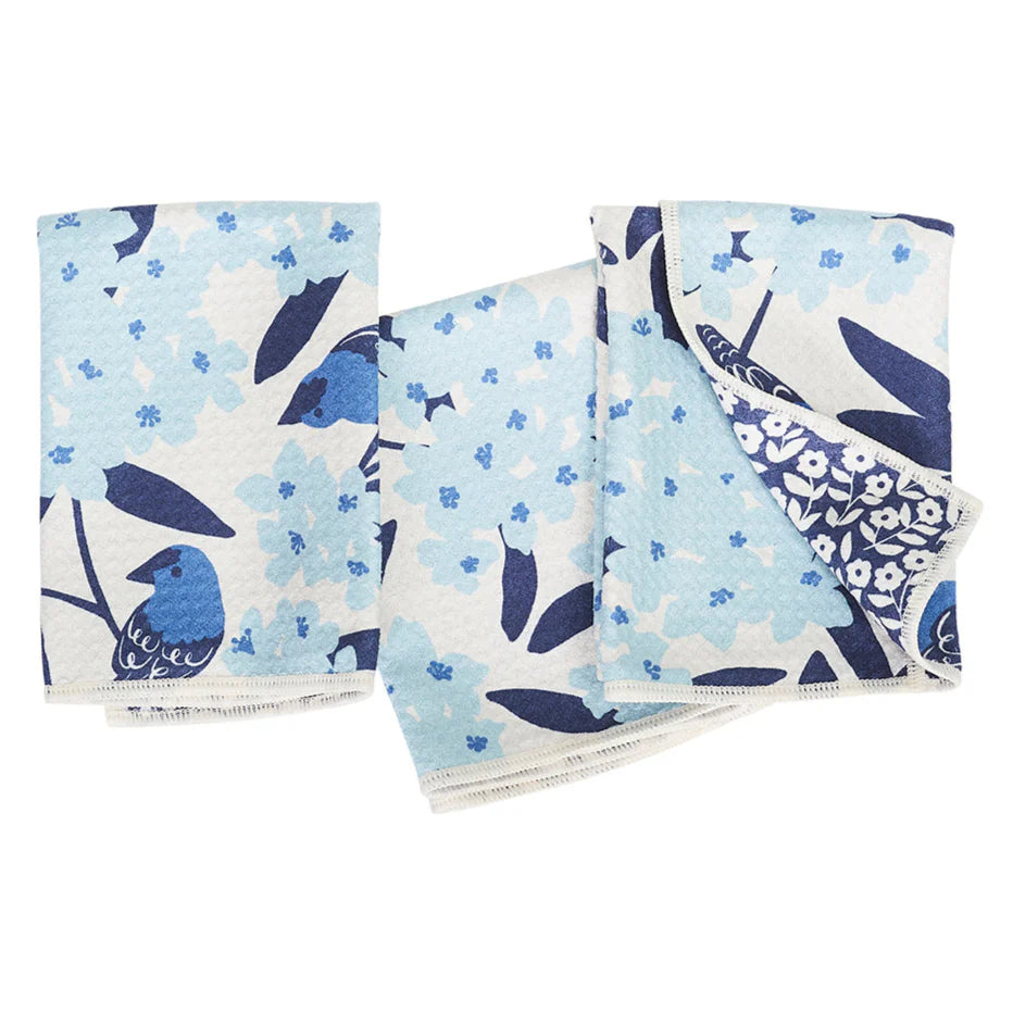 Set of four fabric swatches with blue and white floral and bird patterns on a light blue background.
