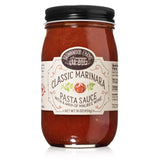 A jar of MILO'S CLASSIC MARINARA pasta sauce with a label showing the brand and product name, along with an illustration of a tomato. The sauce is visible through the clear glass jar, and it appears to be red.