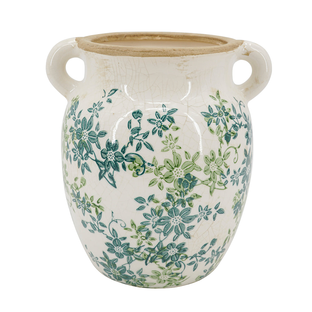A ceramic jar with a glossy white glaze, featuring a hand-painted green and teal floral pattern and a rustic beige rim, set against a plain white background.