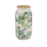 A ceramic jar with a cream-colored body, decorated with a green and teal floral vine pattern, and finished with a natural beige clay rim on a white background.