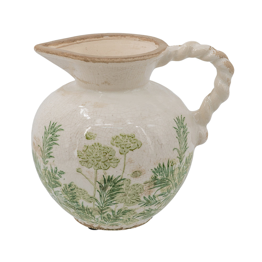 A vintage ceramic pitcher with a rounded body, twisted handle, and wide pouring spout, decorated with green botanical patterns on a cream-colored glaze.