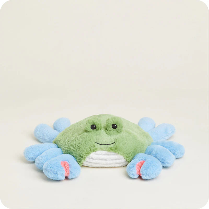 Plush crab toy with a smiling face on a light beige background