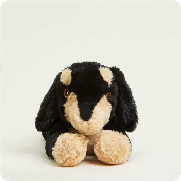 Plush toy dog with black and beige fur on a white background
