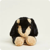 Plush toy dog with black and beige fur on a white background