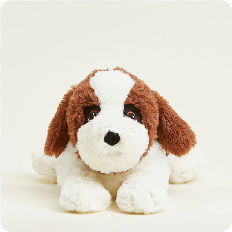 Stuffed dog toy with brown and white fur on a light background