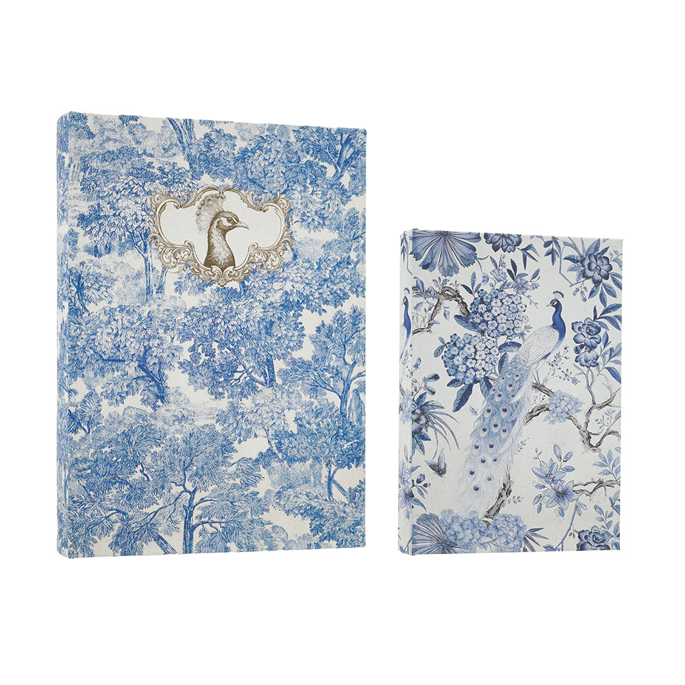 Two decorative boxes with blue and white toile-style prints, one featuring a peacock and floral motif and the other a bird framed by ornate detailing, shown on a white background.