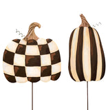 Two decorative pumpkins with checkered and striped patterns on a white background
