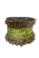 A spool of decorative trim featuring a wide olive green velvet band with fringed edges and metallic gold tinsel fringe, shown on a plain white background.