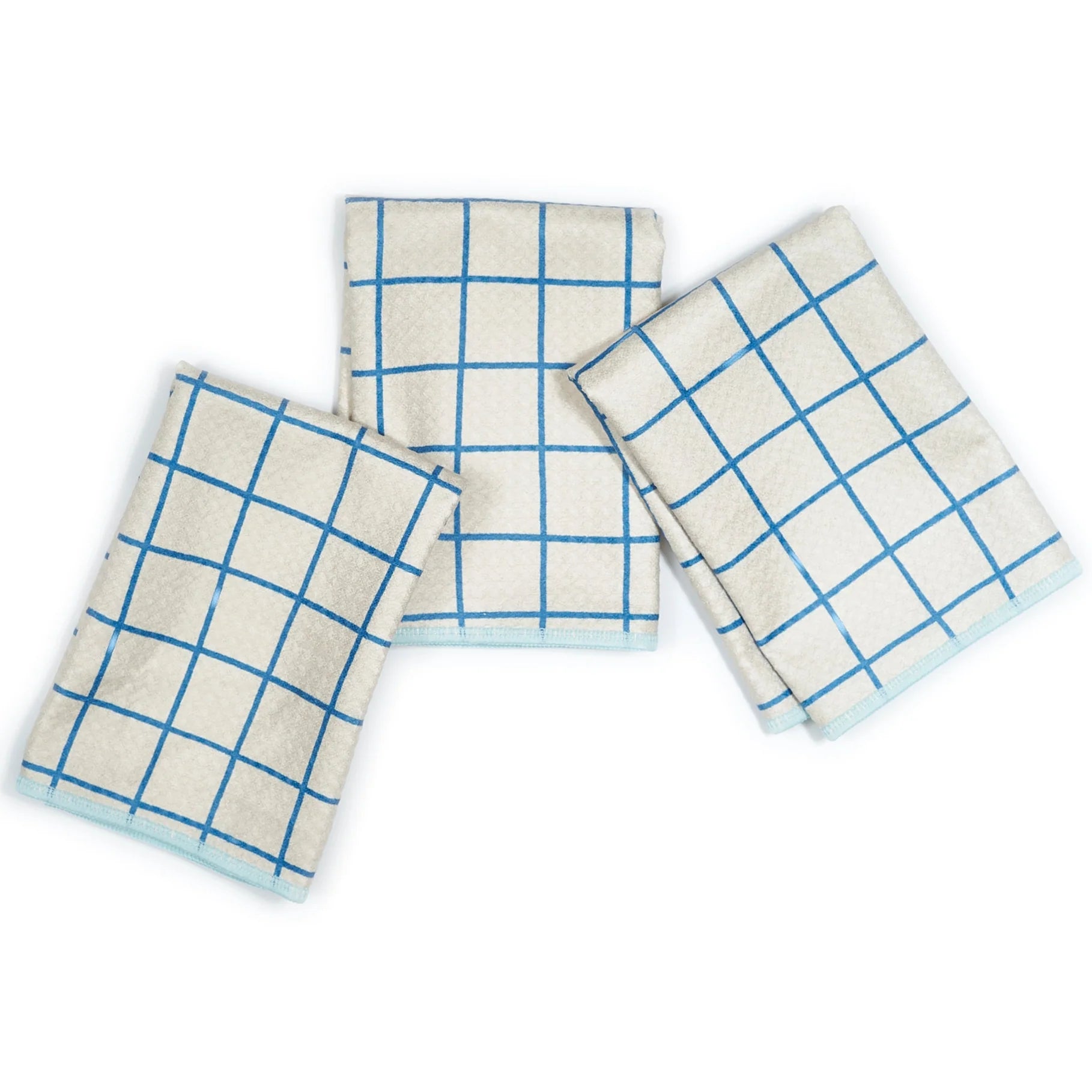 Three kitchen towels with blue grid pattern on a white background