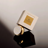 Glasshouse Car Diffuser packaging on a reflective surface with a gradient background
