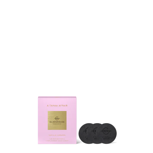 Pink packaging with gold label and two black coasters on a white background