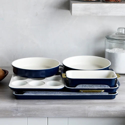 Set of blue and white ceramic cookware on a kitchen counter.