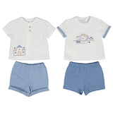 Two outfits for children, each consisting of a white top with a castle and a different design, and blue shorts. One top has buttons at the collar, and the other has a round neckline.