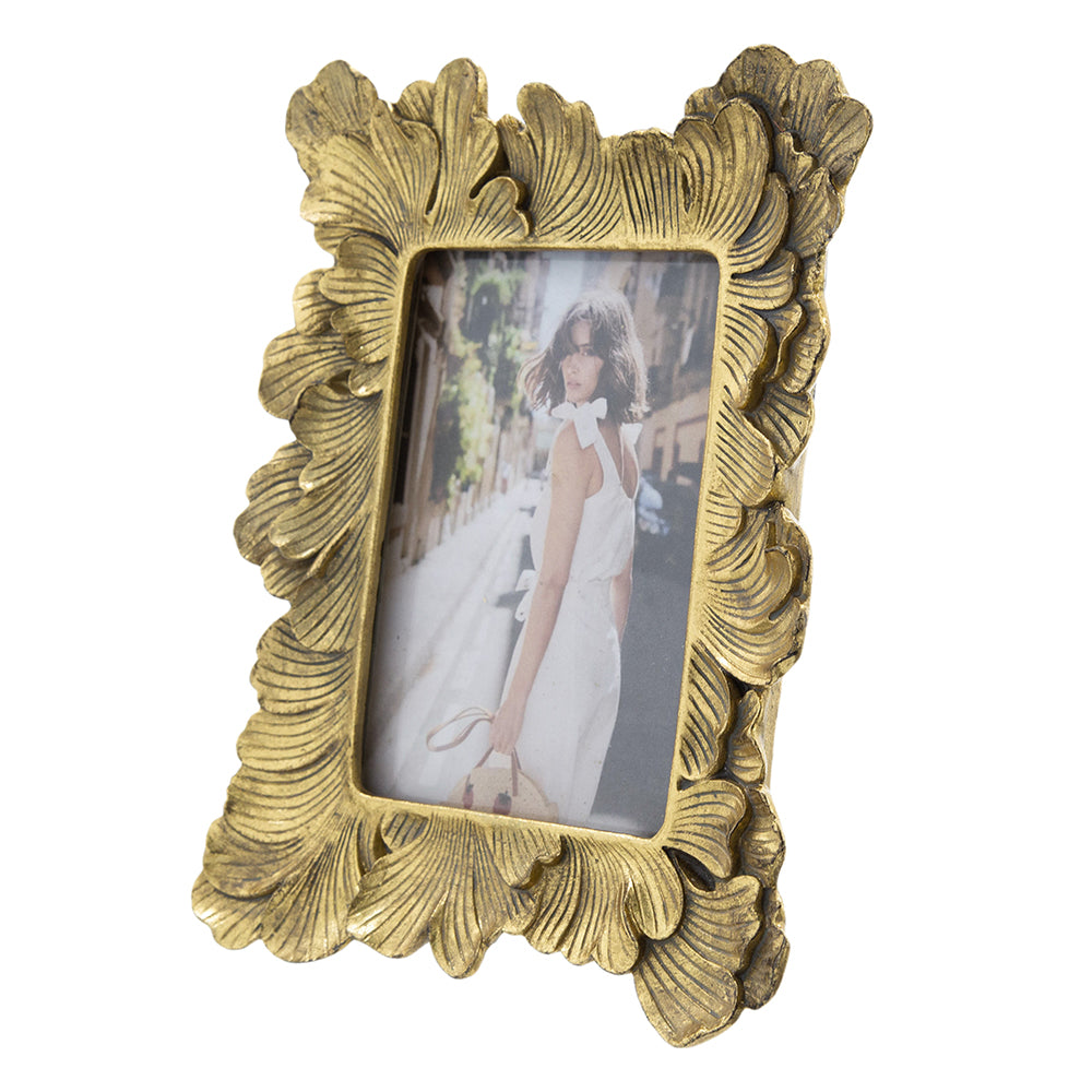 Decorative gold photo frame with a floral design on a white background