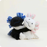 Two plush toys, one black and blue, the other white with pink accents, on a light gray background.