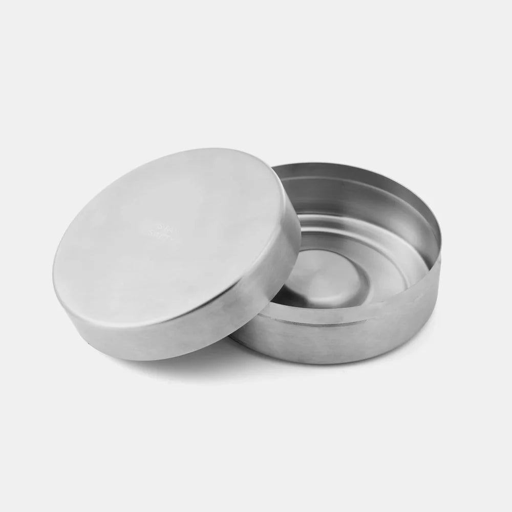 Silver metal container with lid on a white background