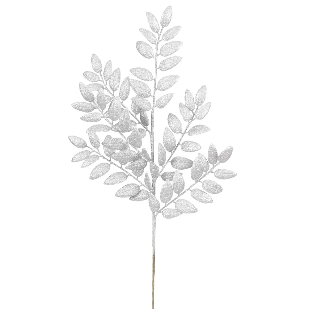 Silver glitter artificial leafy branch with multiple small oval leaves on a stem, shown against a plain white background.