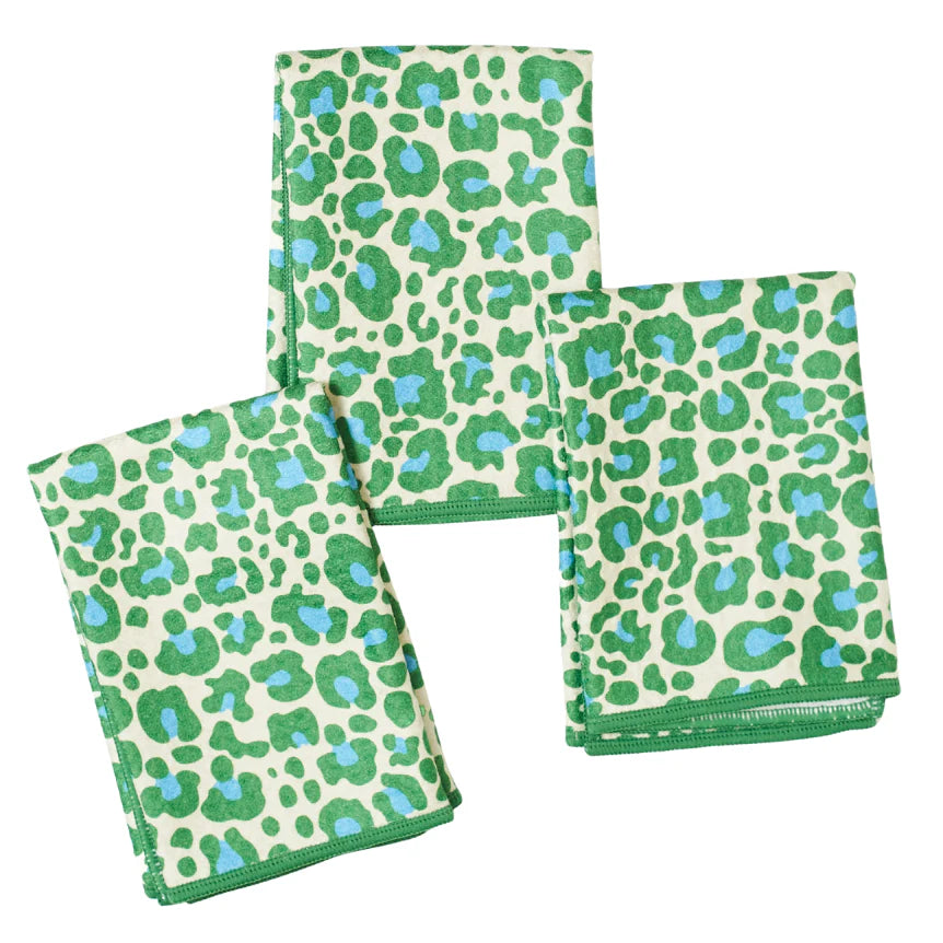 Three green and blue patterned cloths on a white background
