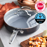 Gray frying pan with a lid on a kitchen counter with food ingredients, featuring Food Network logos.