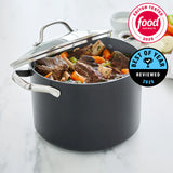Black pot with food inside on a marble surface, featuring Food Network logos.