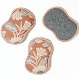 Three floral-patterned pads on a white background