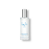 Clear bottle with silver cap labeled 'inis' on a white background