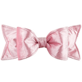 Pink bow with a subtle pattern on a white background