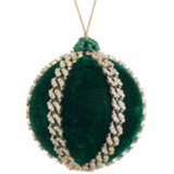 Green decorative ball ornament with braided design on a white background