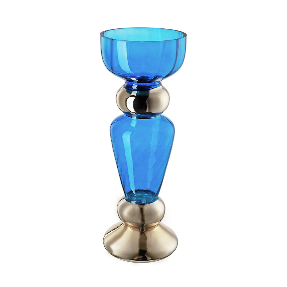 A blue glass candle holder with polished silver-tone metal accents at the neck and base, shown on a plain white background.