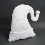 White ghost-shaped pillow on a dark background