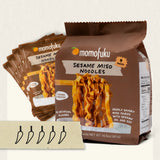 Momofuku Sesame Miso Noodles packaging with a stack of noodles on a white background