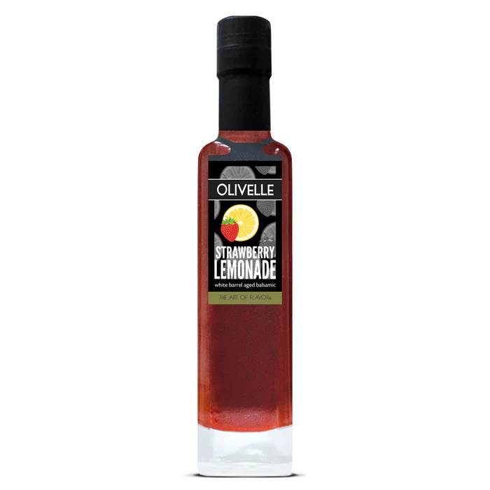 A bottle of Olivelle Strawberry Lemonade infused barrel aged balsamic vinegar, featuring a black cap and a black label with a strawberry and lemon graphic, set against a plain white background.