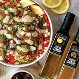 Plated dish with falafel, rice, and vegetables, accompanied by bottles of Olivelle olive oil.
