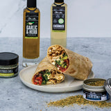 Wrap with ingredients and olive oil bottles on a gray surface