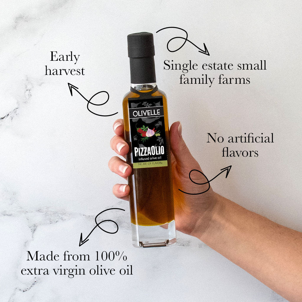 Hand holding a bottle of Olivelle Pizzaiolo olive oil with text highlighting features on a marble background