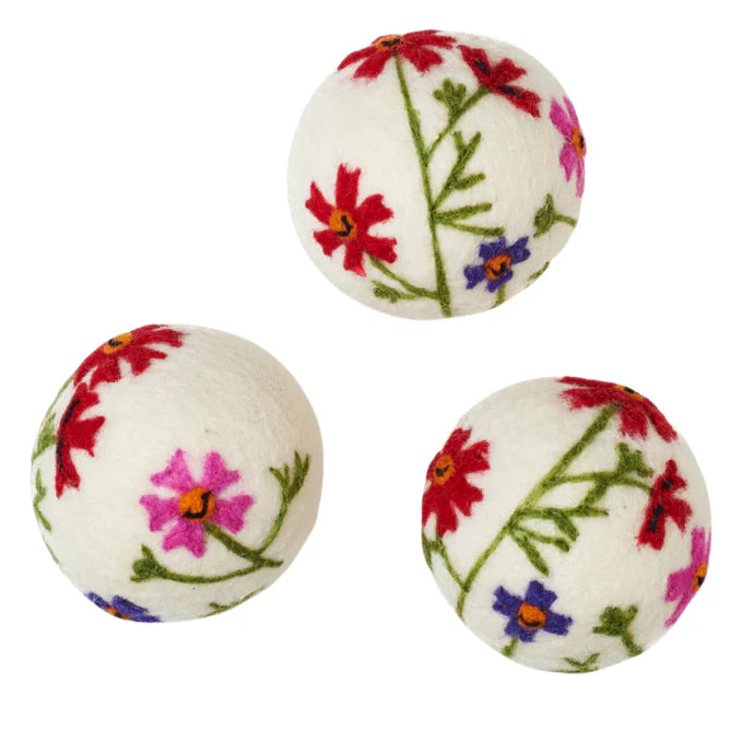Three white balls with floral patterns on a white background