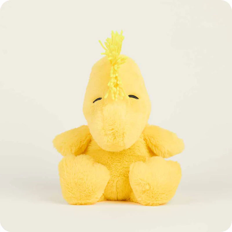 Yellow plush toy with a mohawk on a white background