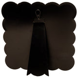 Black scalloped edge board with a clip on a white background