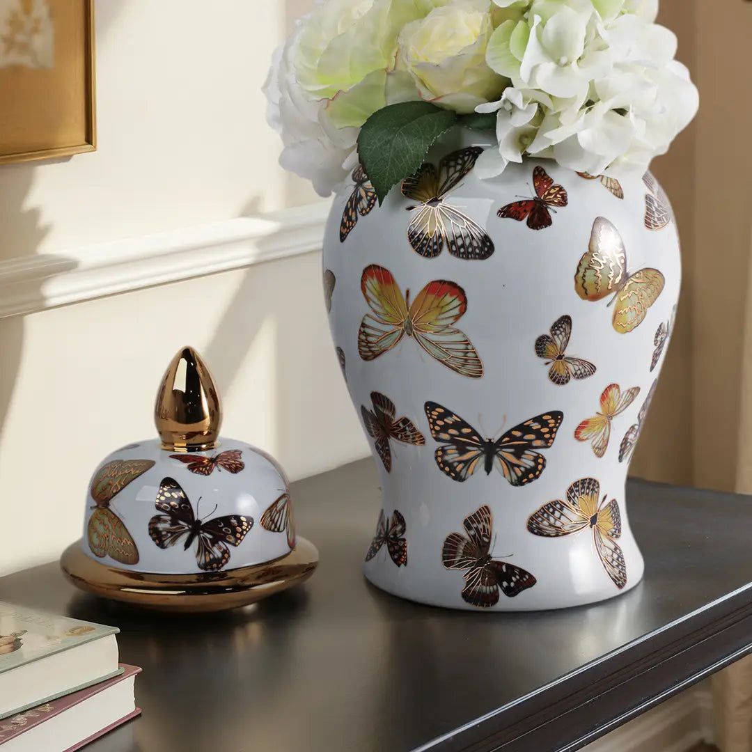 Decorative ceramic vase with butterfly design on a surface