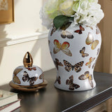 Decorative ceramic vase with butterfly design on a surface