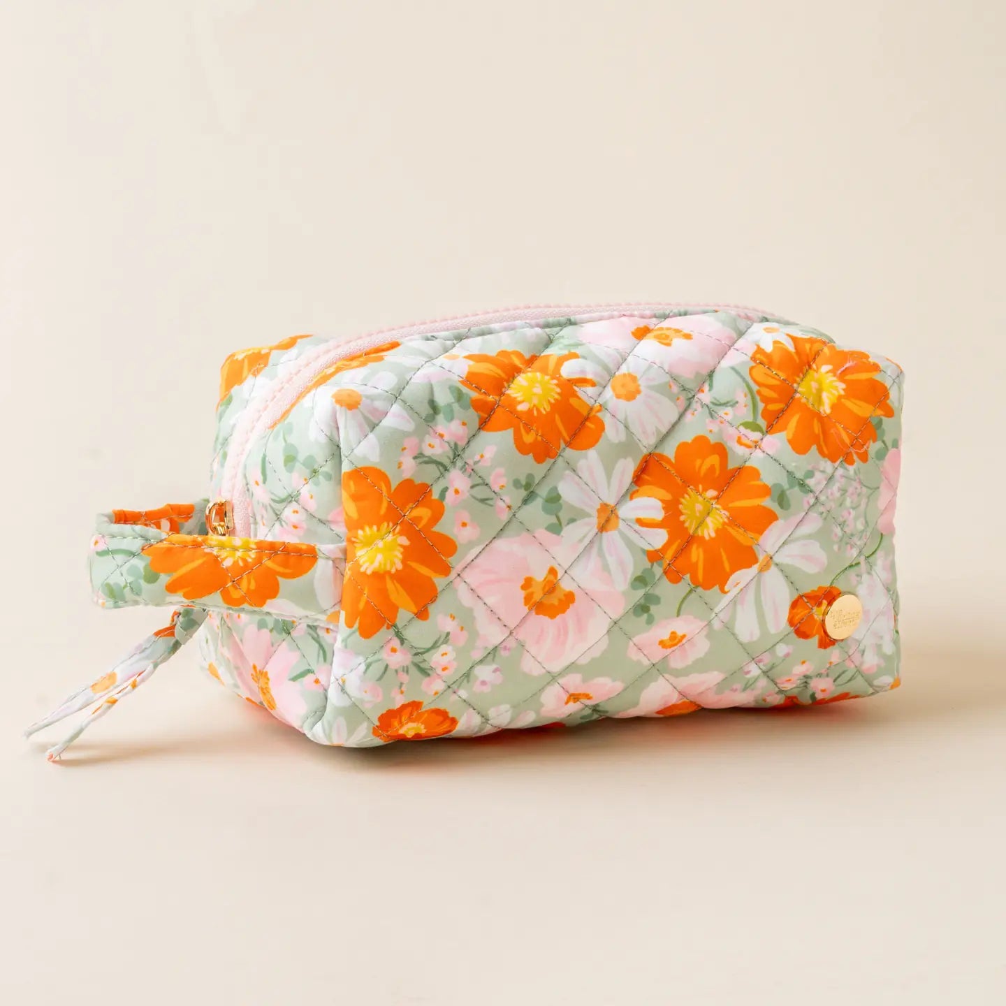 A multicolored floral cosmetic bag with a zipper.