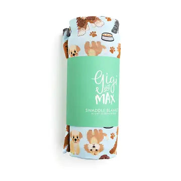 A swaddle blanket with a pattern of dogs and cat paws, rolled up with branding in the center that reads 'Gigi & Max Swaddle Blanket'.