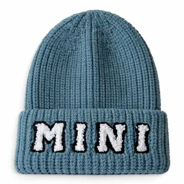 A blue ribbed knit beanie hat with a folded cuff featuring the word 'MINI' embroidered in white with black outlines across the front.