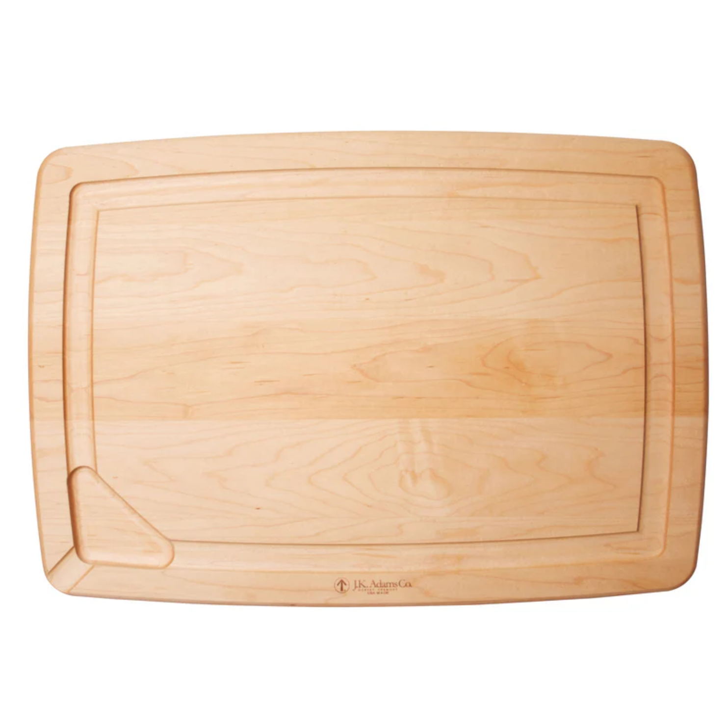A rectangular wooden cutting board with grooves and a curved indentation on one corner, with the brand 'JK Adams' engraved near the bottom edge.