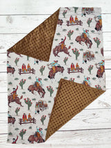 Blanket with cowboy and horse pattern on a wooden surface