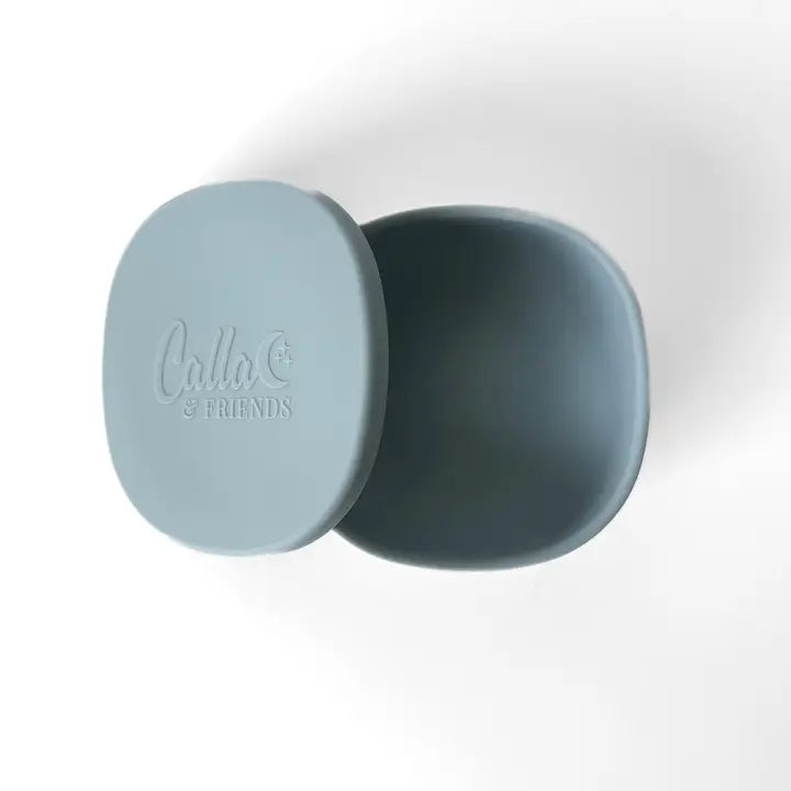 Two blue silicone lids with 'Ollie & Friends' branding on a white background