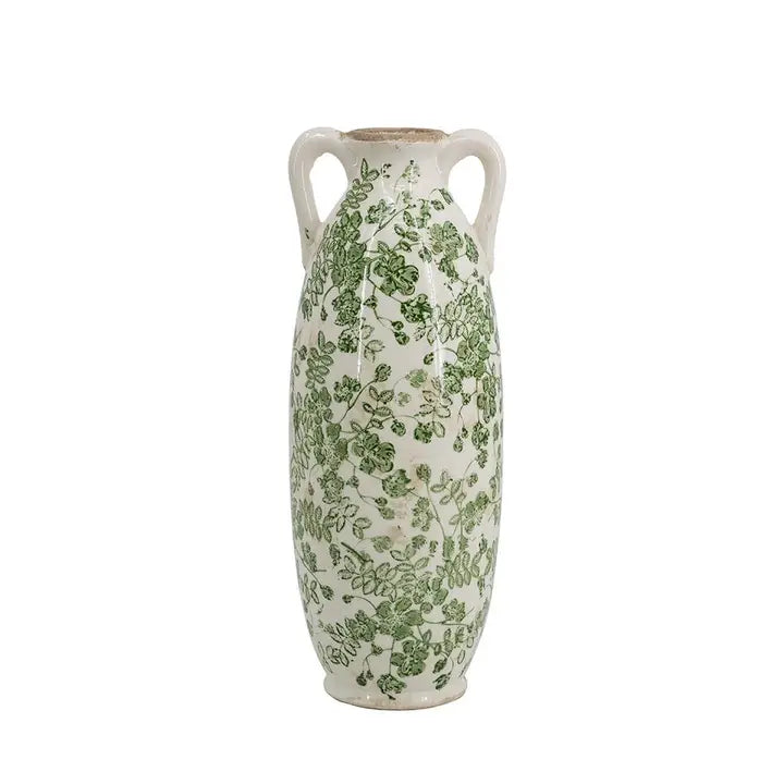 Ceramic vase with green floral pattern on a white background
