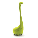 Green dinosaur-shaped tea infuser on a white background